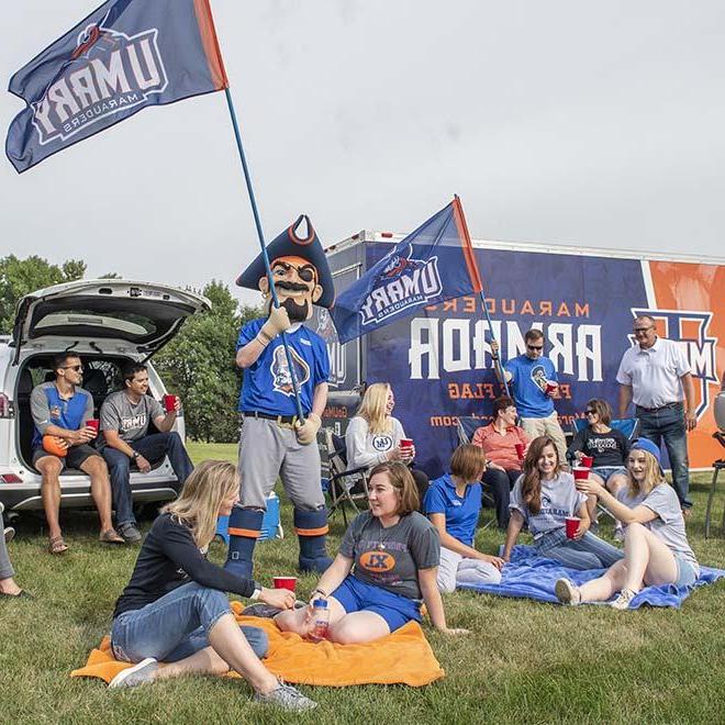 Max the Marauder at a tailgate with faculty and students.