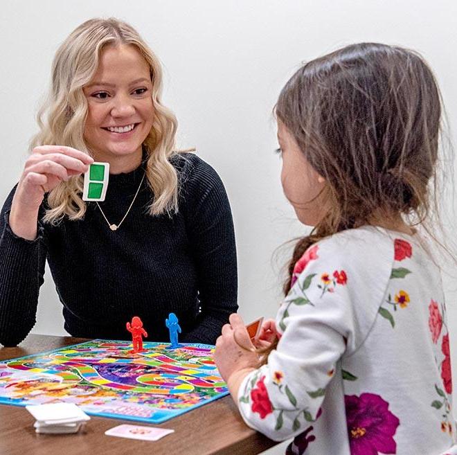 Speech-language pathology student working with a child.